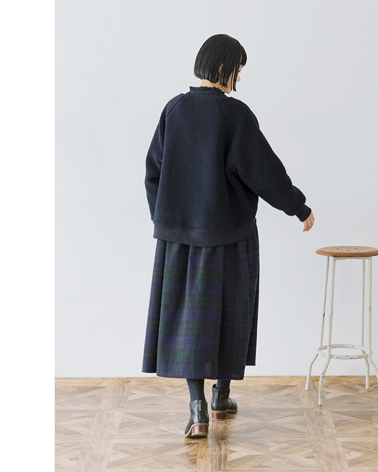 チェック柄ワンピースとボアジャケットの後ろ姿