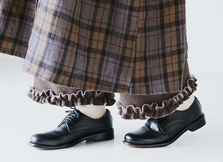 ブラウンカラーの裾フリルデザインが際立つニットパンツの足元ディテール