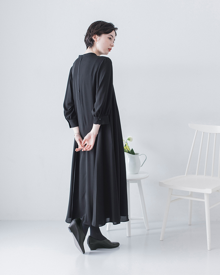 DOUBLETREEのウェッジソールパンプスを黒のロングワンピースと合わせた後ろ姿のコーディネート