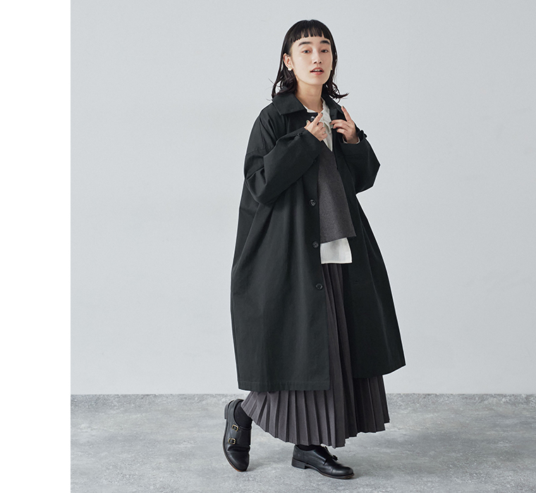 別注｜プリーツパンツのチャコールを着用したモデルがコートを羽織っている