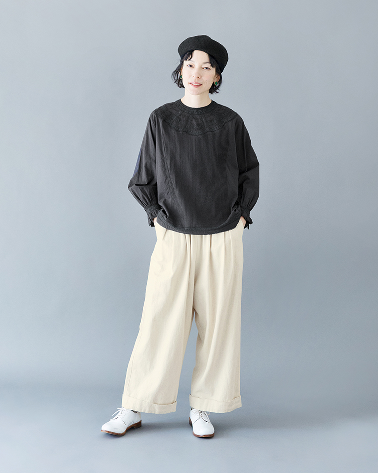 ブラックブラウスにクリームカラーのピンタックパンツを合わせた正面コーディネート（刺しゅう入り）