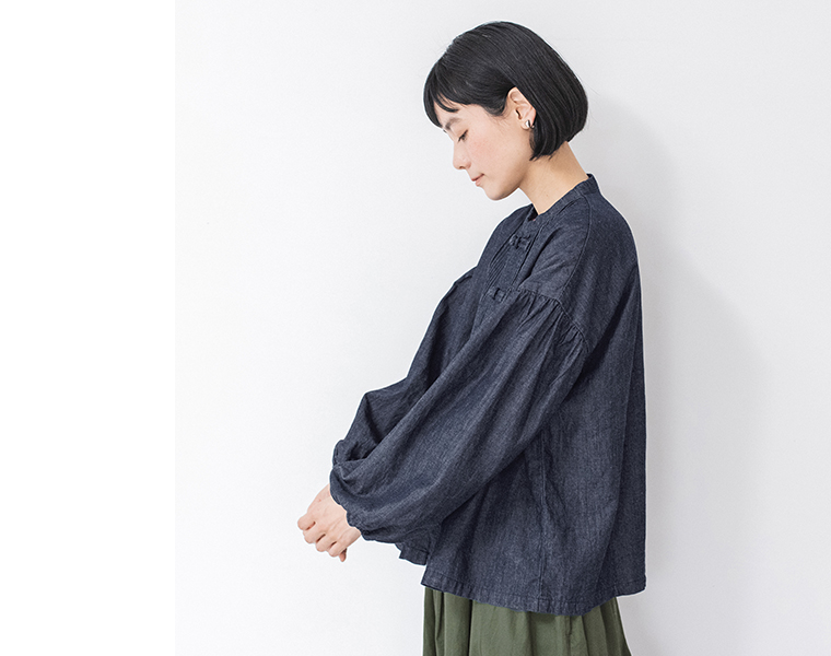 コットンリネンデニム チャイナボタンブラウスを着用した女性モデルのサイドシルエット