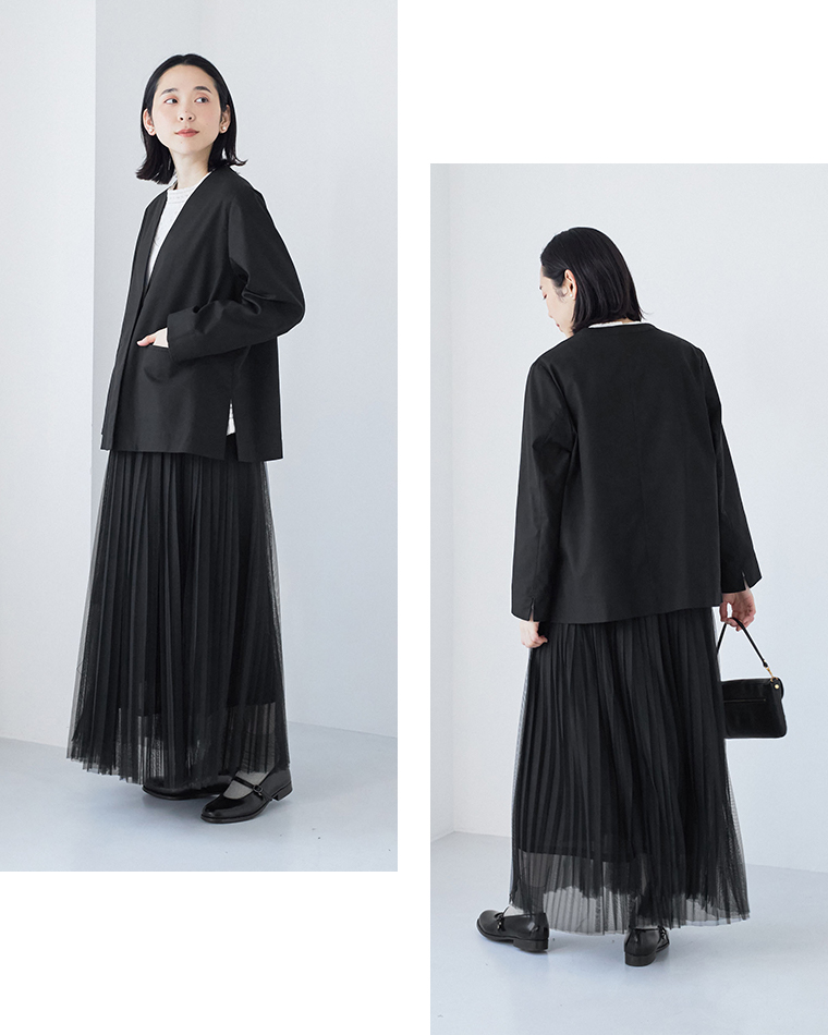 ブラックのジャケットとプリーツスカートを合わせた前後スタイリング（白トップス・ハンドバッグ付き）