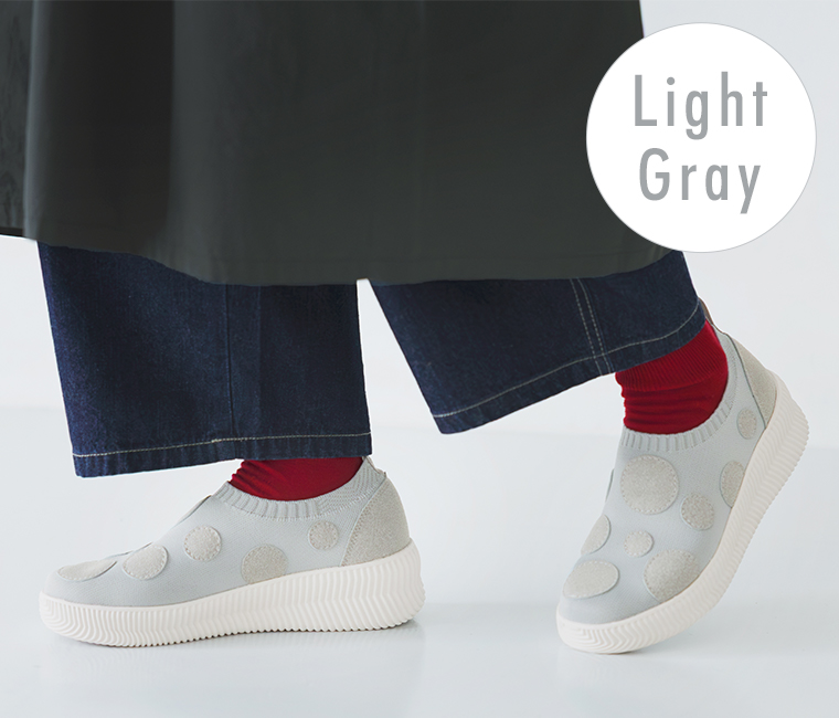ライトグレーのドットスリッポンスニーカーの足元ディテールカット