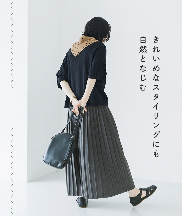 着るだけでサマになる フリル5分袖Tシャツ ブラックを着たモデルが後ろ向きで歩いている