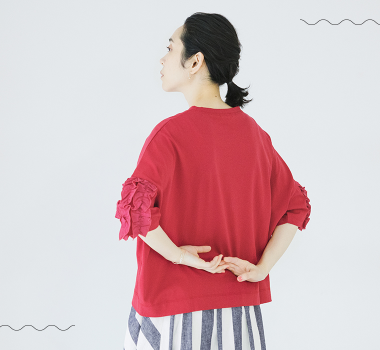 着るだけでサマになる フリル5分袖Tシャツ レッドを着たモデルが後ろ向きで立っている