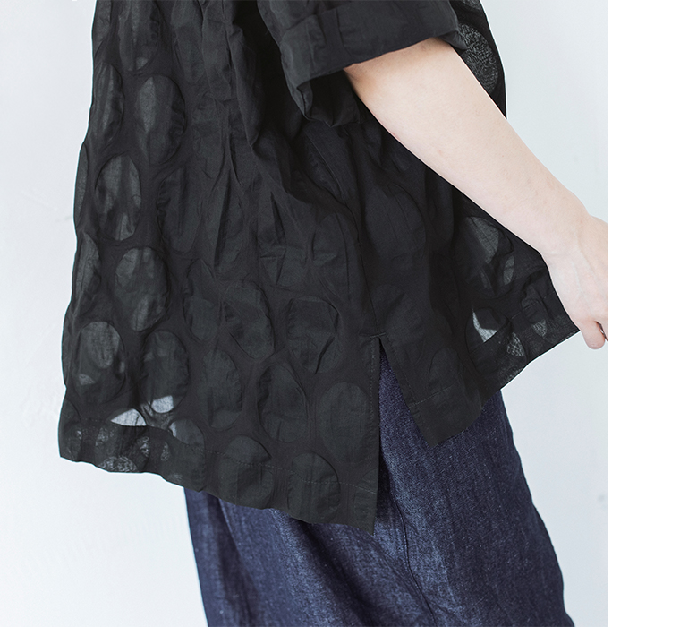 ブラックのシアーシャツの裾スリットと楕円ドット柄の質感を写したディテールカット