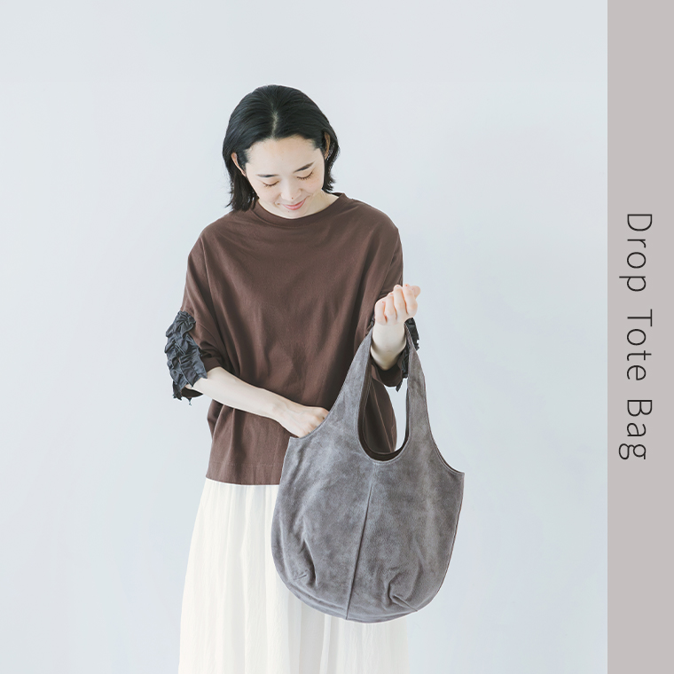 TOKYO LEATHER FACTORY 洗えるピッグスエード ドロップトートバッグを持った女性モデルの上半身スタイル