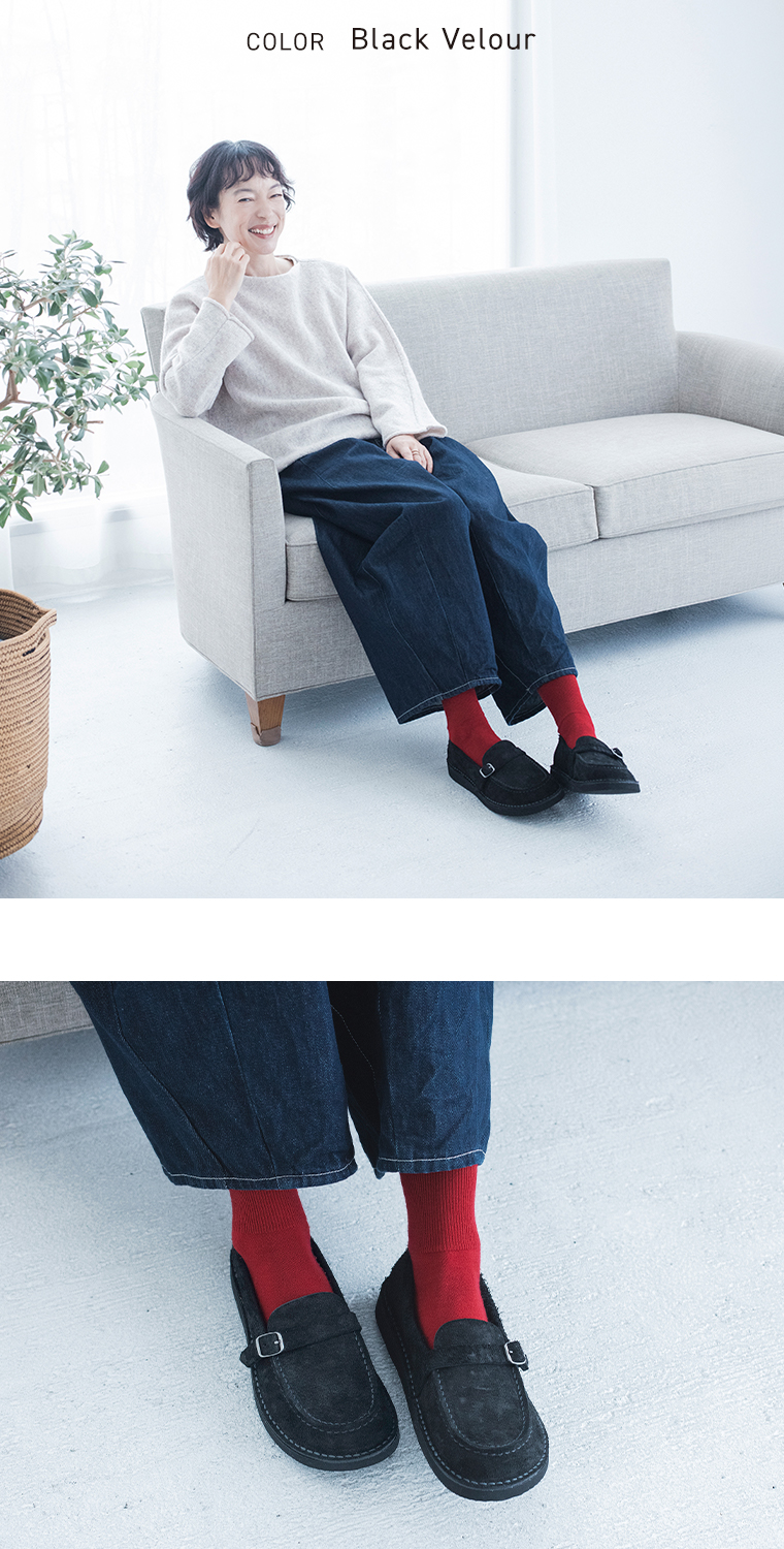 ブラックベロアのローファーをデニムパンツと赤いソックスに合わせた着こなし