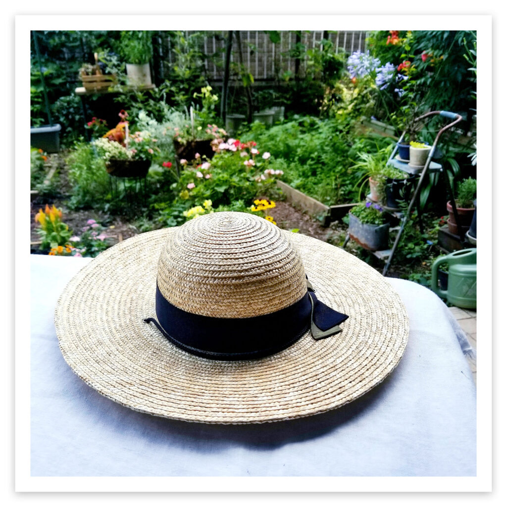 麦わら帽子とお庭の画像